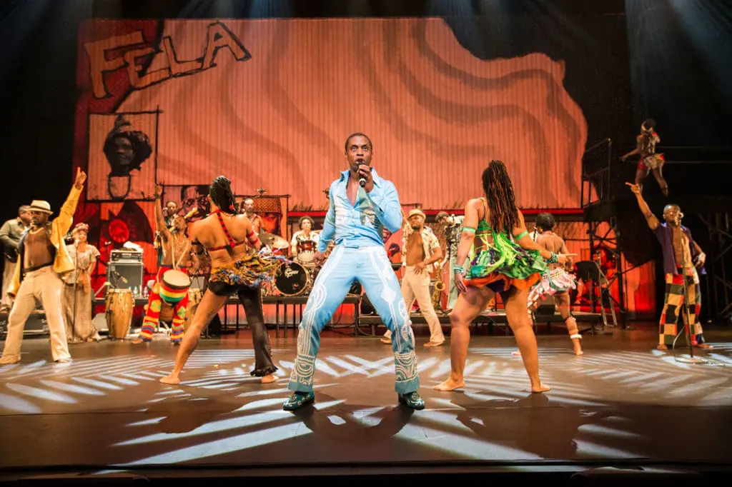 Fela! The Musical performance photo featuring a man signing, full band and African dancers