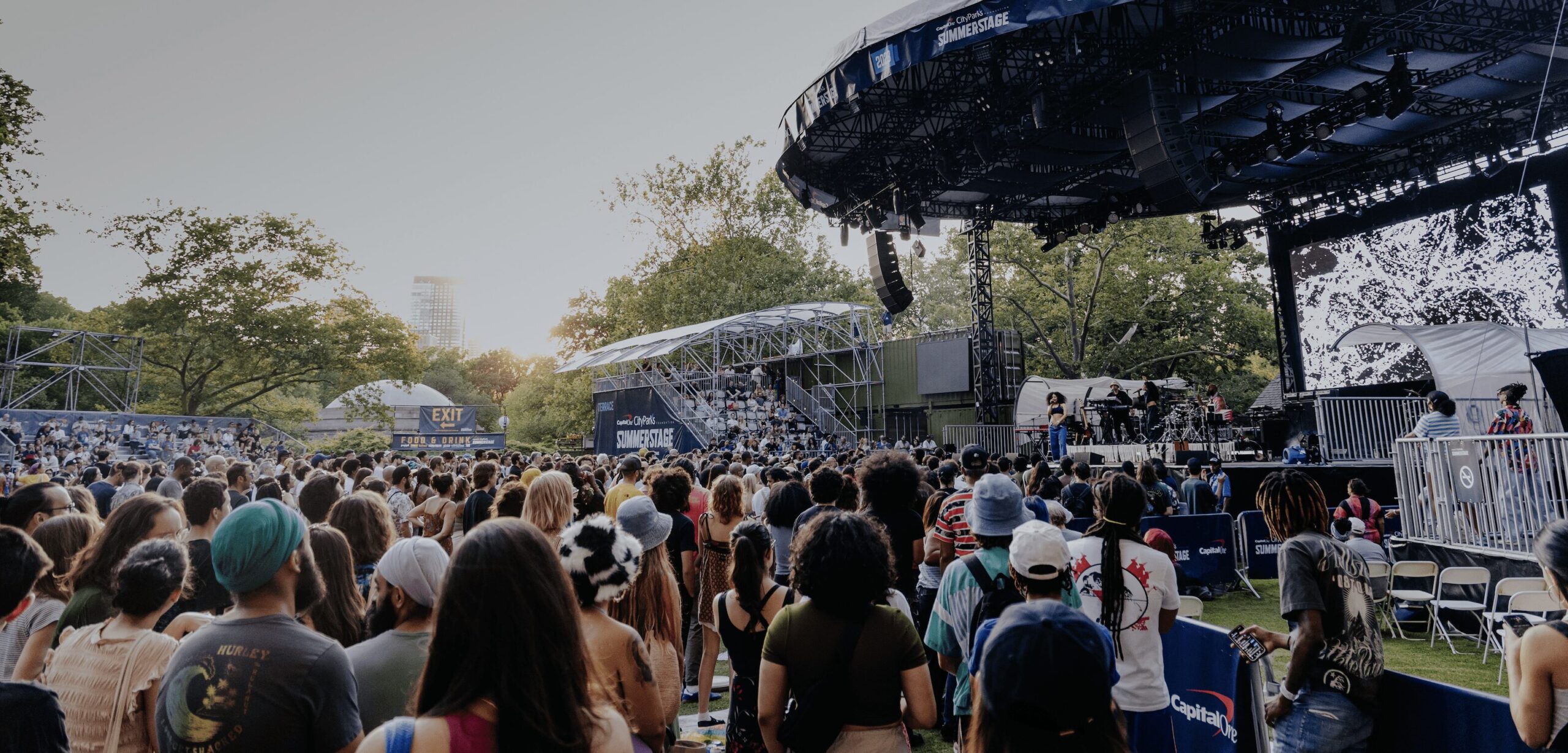 Crowded outdoor stage in a park