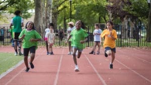 a group of children running on a track