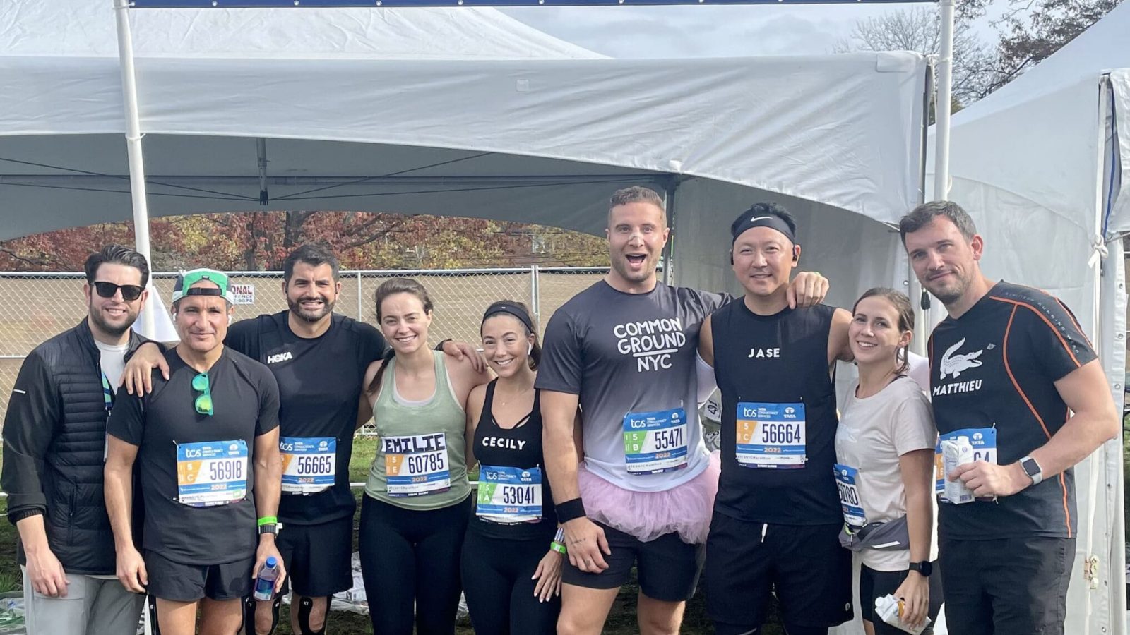 A group of smiling runners for team City Parks Foundation at the New York City Marathon.
