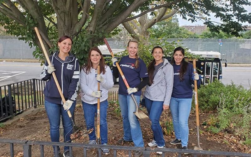 Thumbnail: A sponsor team participating in a group volunteer project cleaning their park