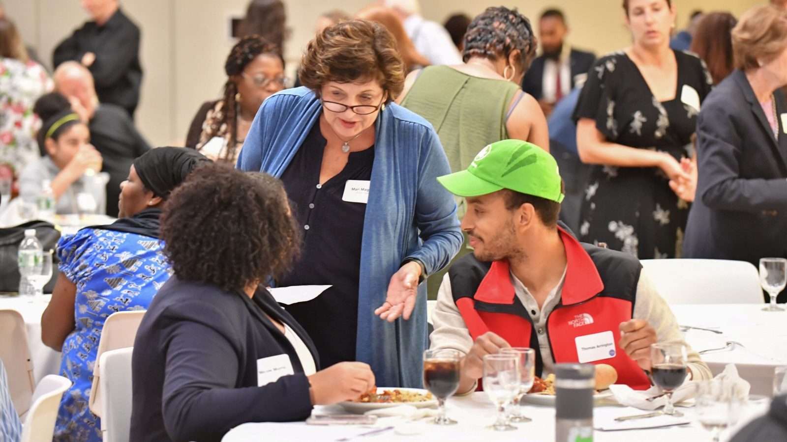 A group of diverse individuals discuss and netowrk with each other at a Partnerships for Parks event.