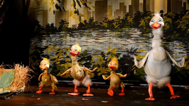 A photo from a performance of Princess, Emperor and the Duck at the Swedish Cottage Marionette Theatre. It features four duck puppets standing together.