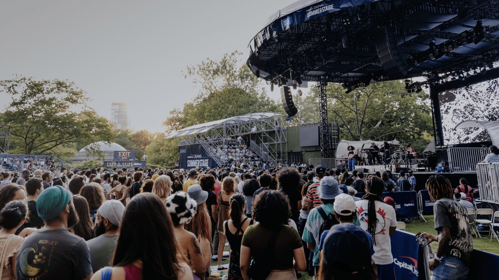 Crowded outdoor stage in a park