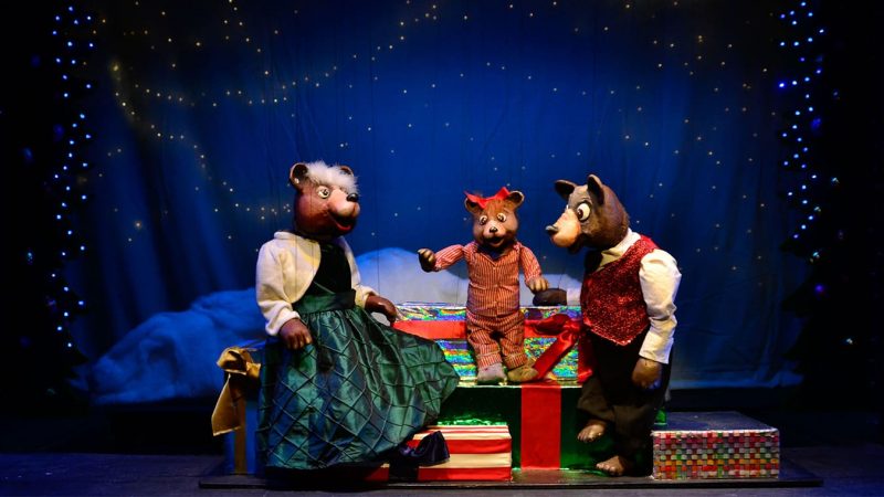 A photo from a performance of the Three Bears at the Swedish Cottage Marionette Theatre. It features the titular three bears from Goldilocks, featuring a "Mama" "Papa" and "Baby" bear.